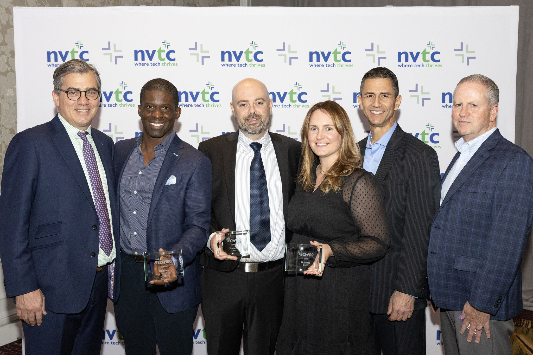 Gunnison Employees, CEO, and VPs at the Nothern Virgina Technology Conference 2023 standing for a group picture holding their awards.