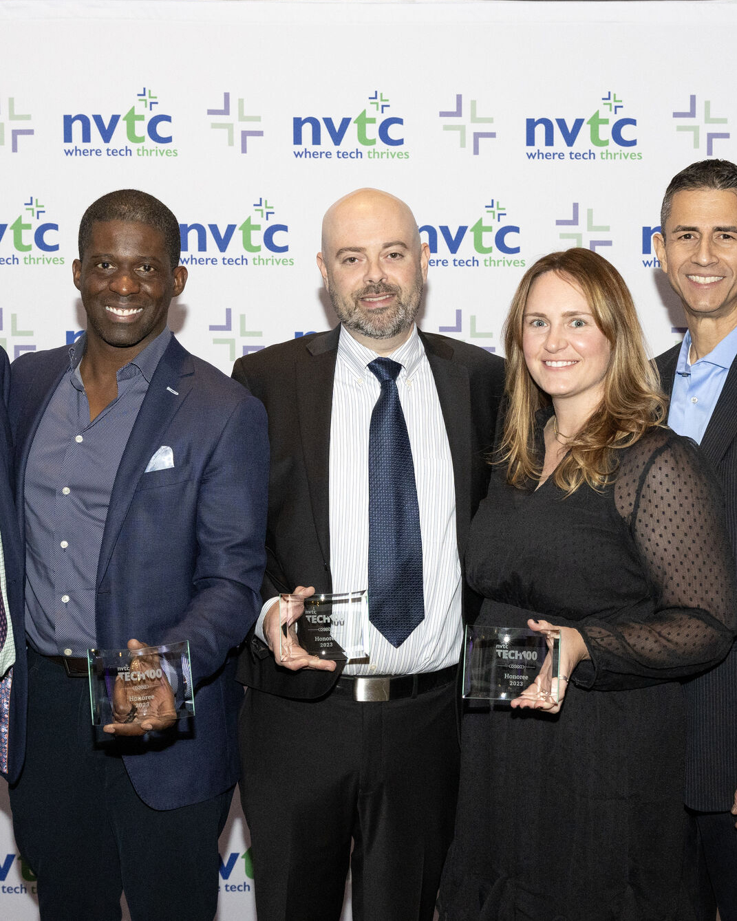 Gunnison Employees, CEO, and VPs at the Nothern Virgina Technology Conference 2023 standing for a group picture holding their awards.